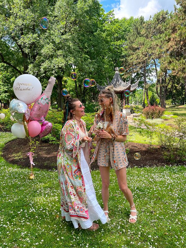 Two women with balloons on the party