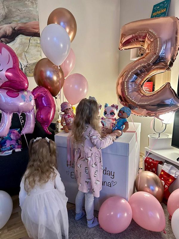 Two little girl with wow box and balloons